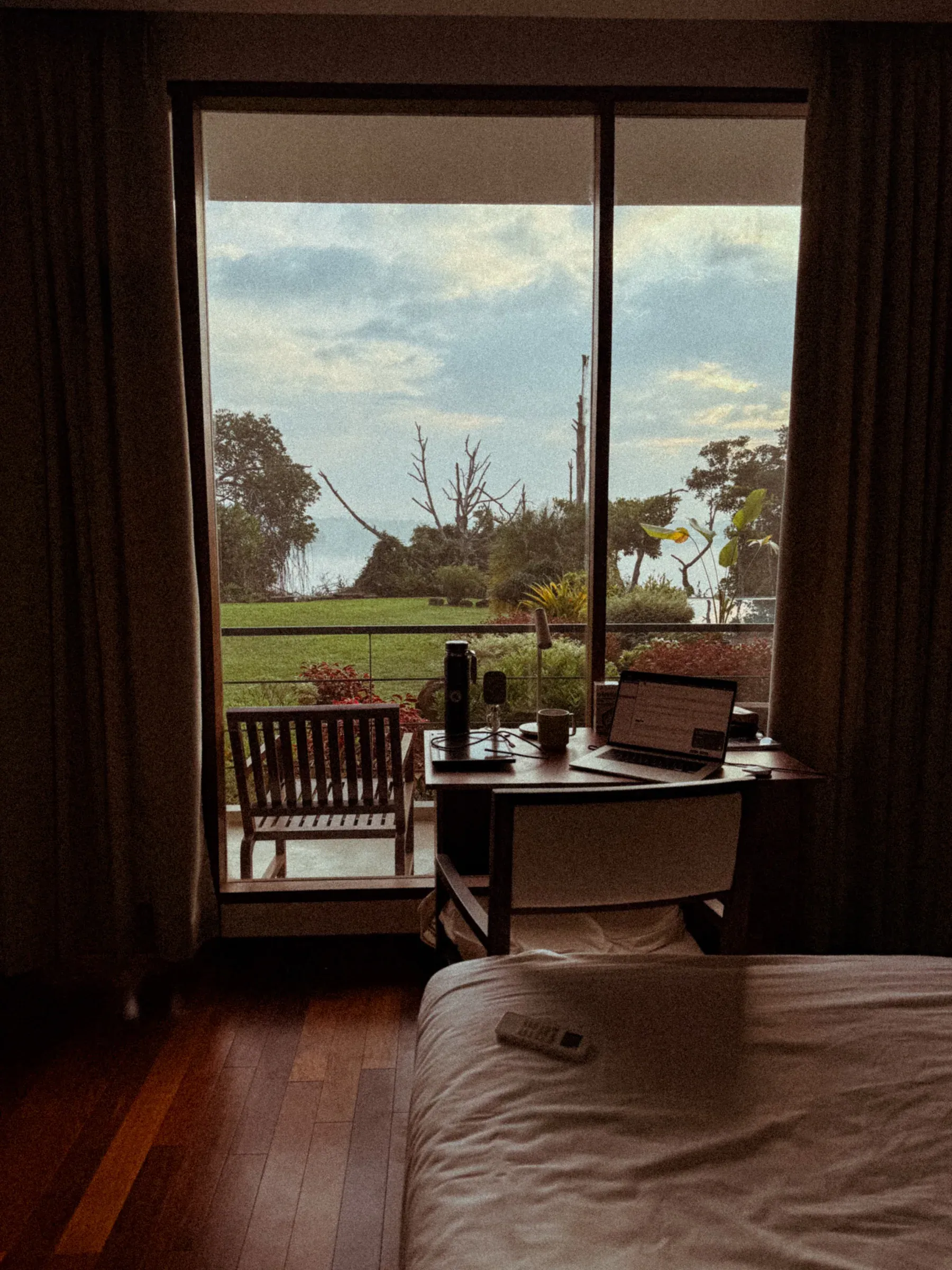 A guest working at a desk with Koggala Lake beyond