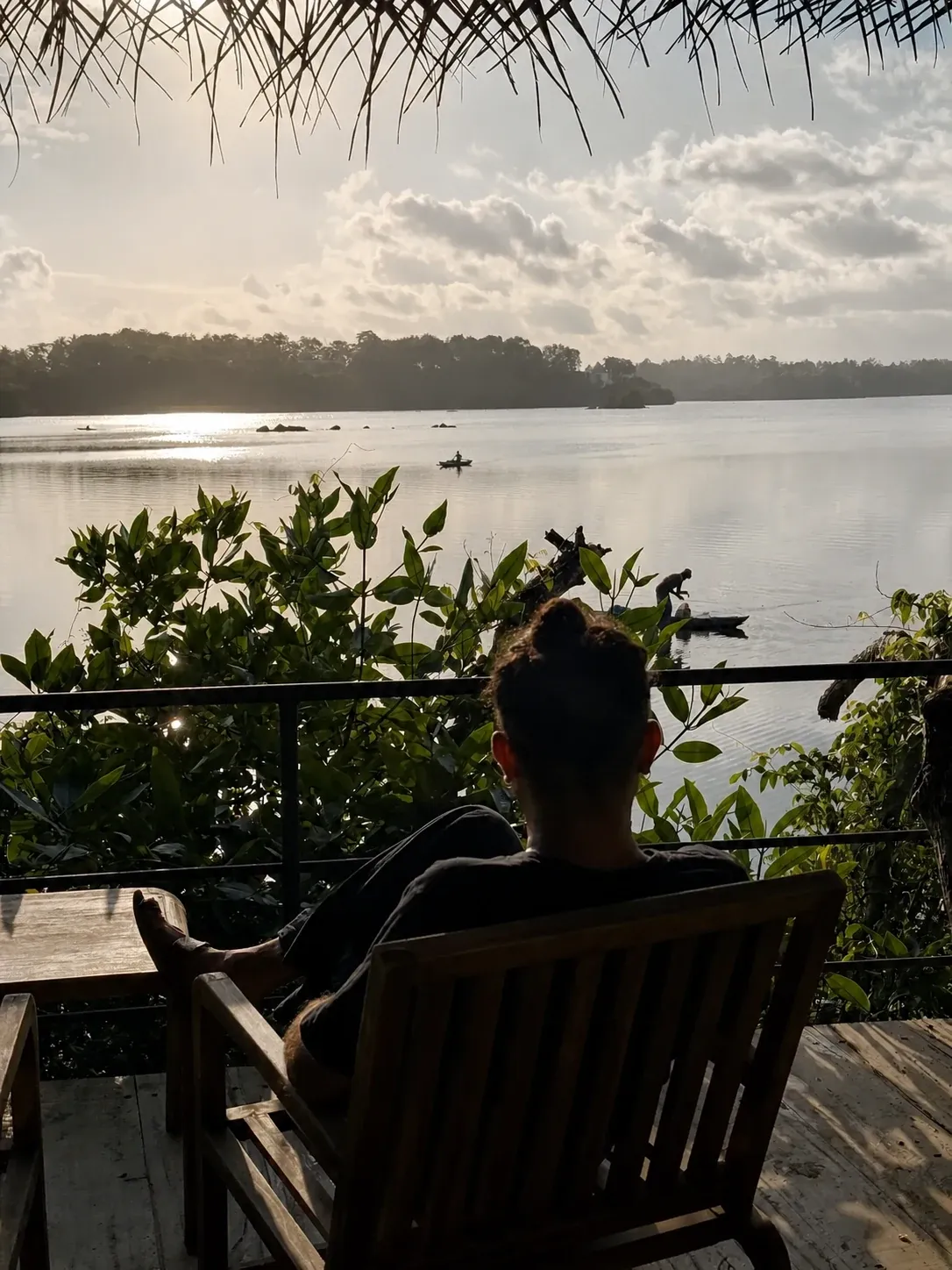 A guest watching sunrise from the lake deck