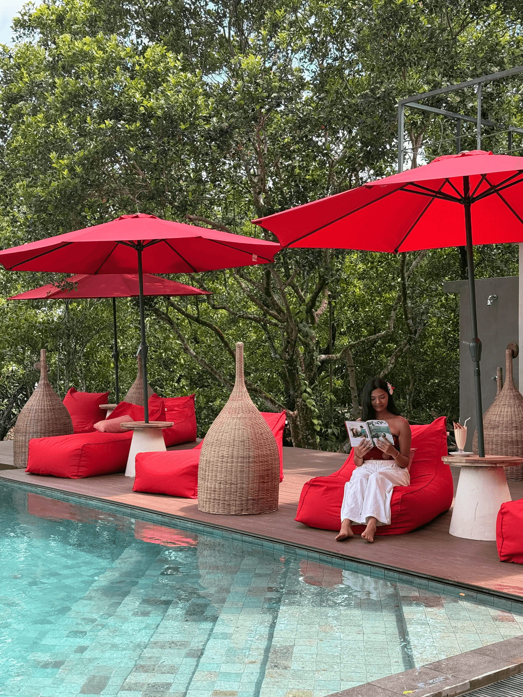 A guest reading quietly beside the pool at Zen Koggala