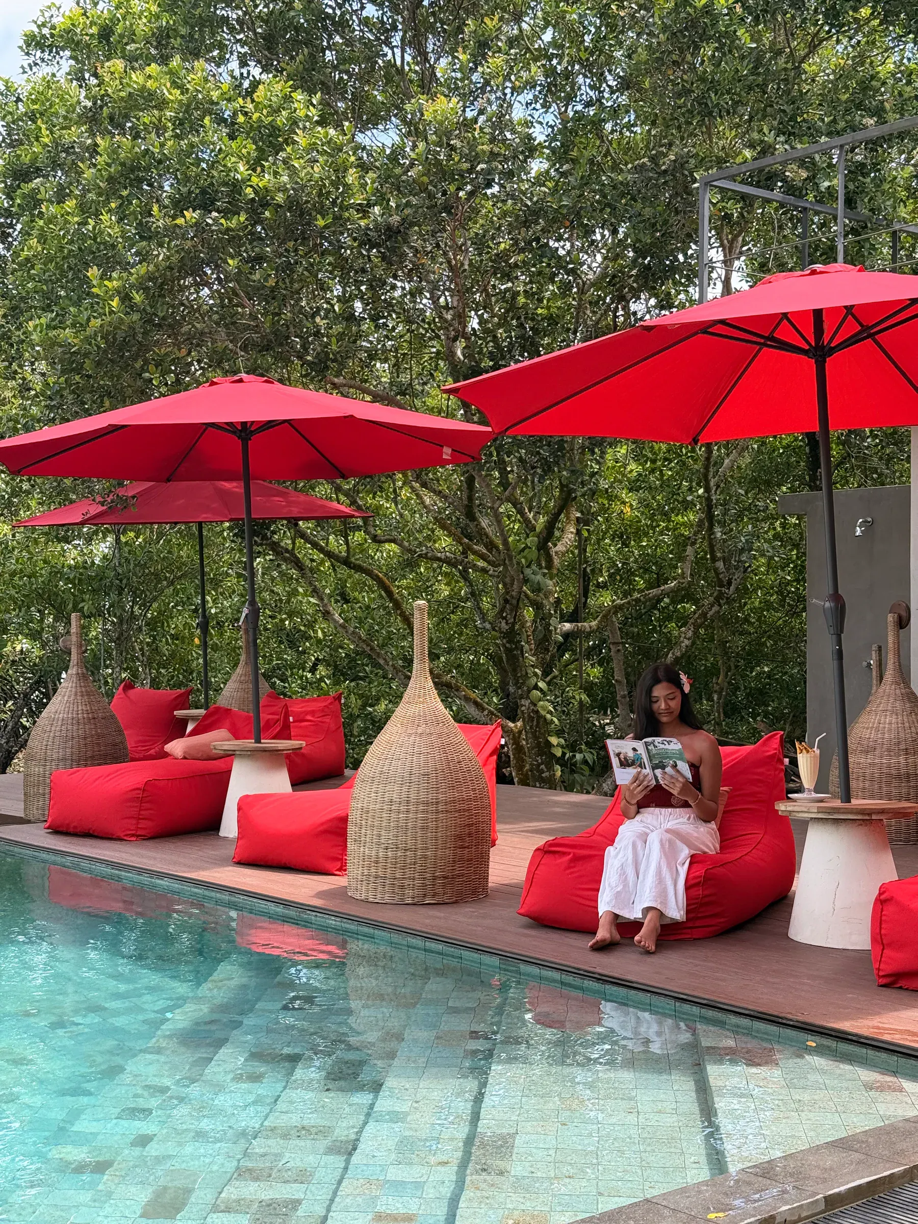 A guest reading quietly beside the pool at Zen Koggala