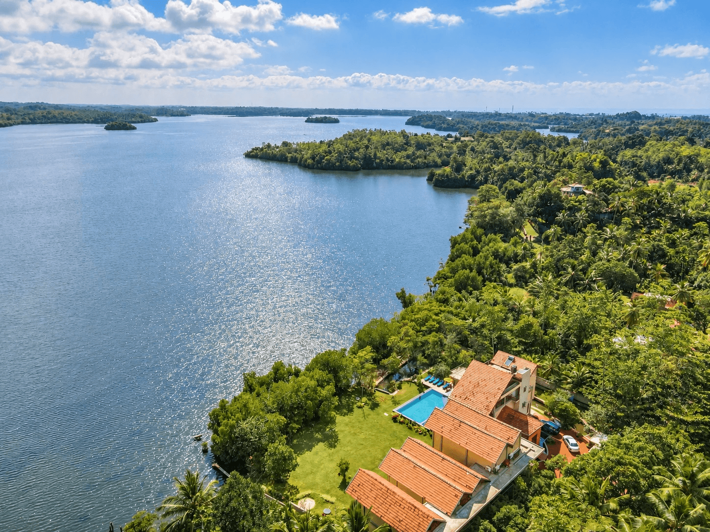 Aerial photograph of Koggala Lake with the Zen Koggala villa, pool and lawn on the shore
